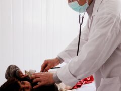 Лекар педиатър преглежда дете в медицински кабинет